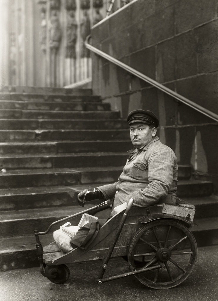 Foto von August Sander zeigt einen Kriegsinvaliden vor der Treppe zum Kölner Dom, 1928,